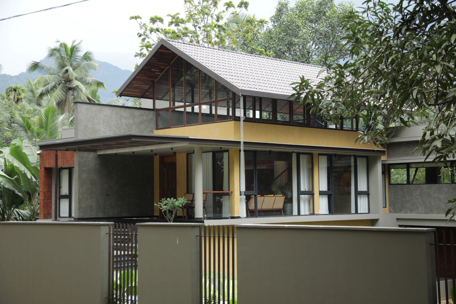 Warm Kerala-style homestay entrance with carved wood details